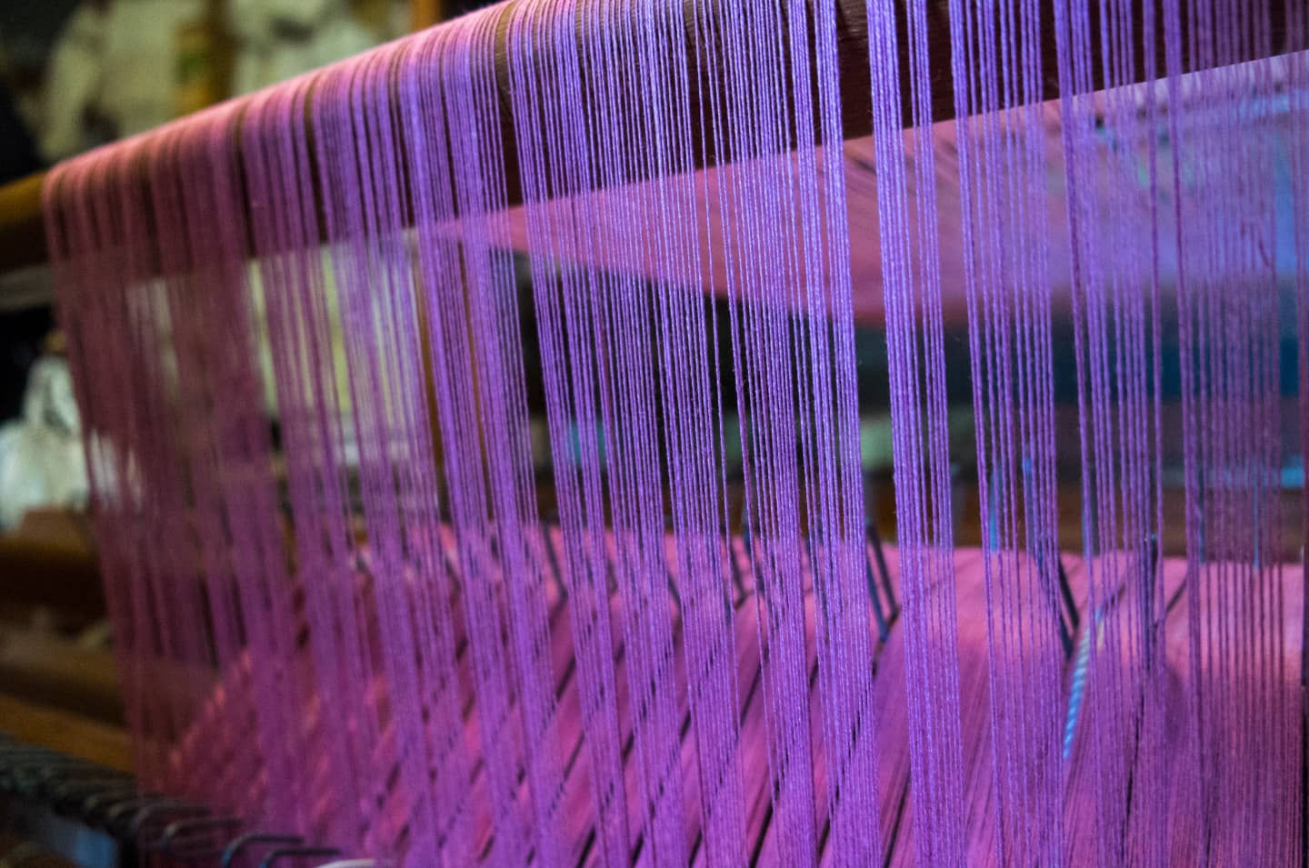 Purple thread in a loom