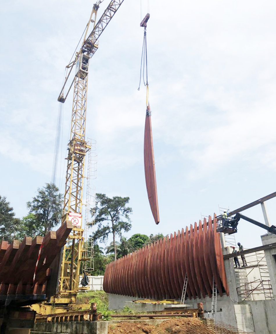 A crane lifts a piece of wood into place during construction of the French embassy in gabon