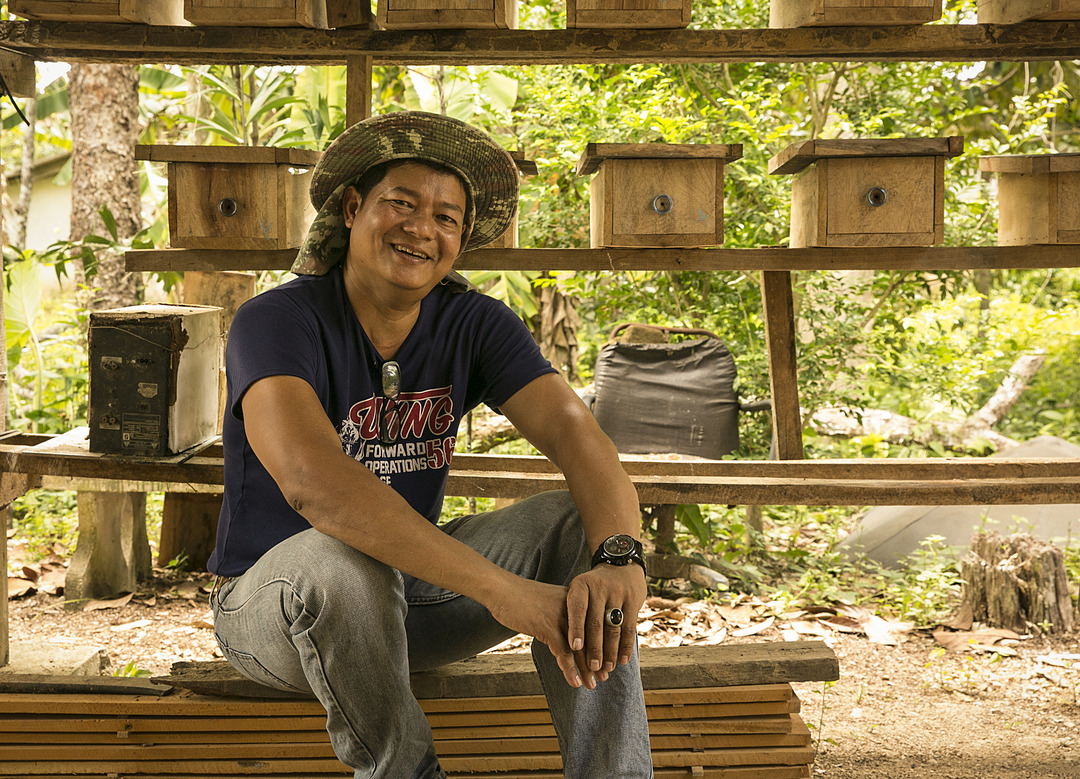 A beekeeper smiling 