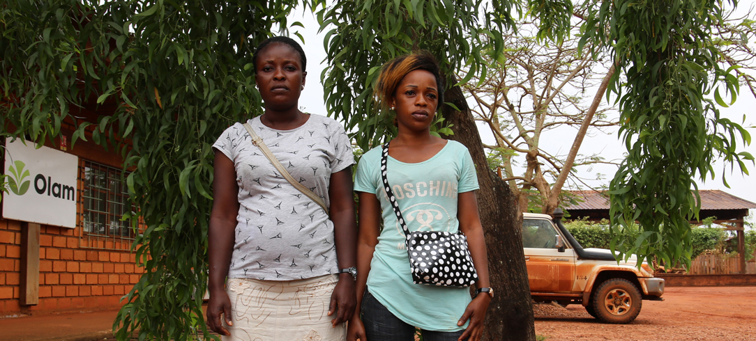 Two Congolese women standing in front of Olam building