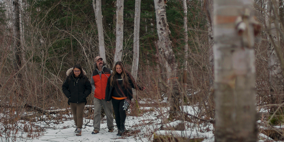 Wahkohtowin Development program members walk through snow forest in Ontario