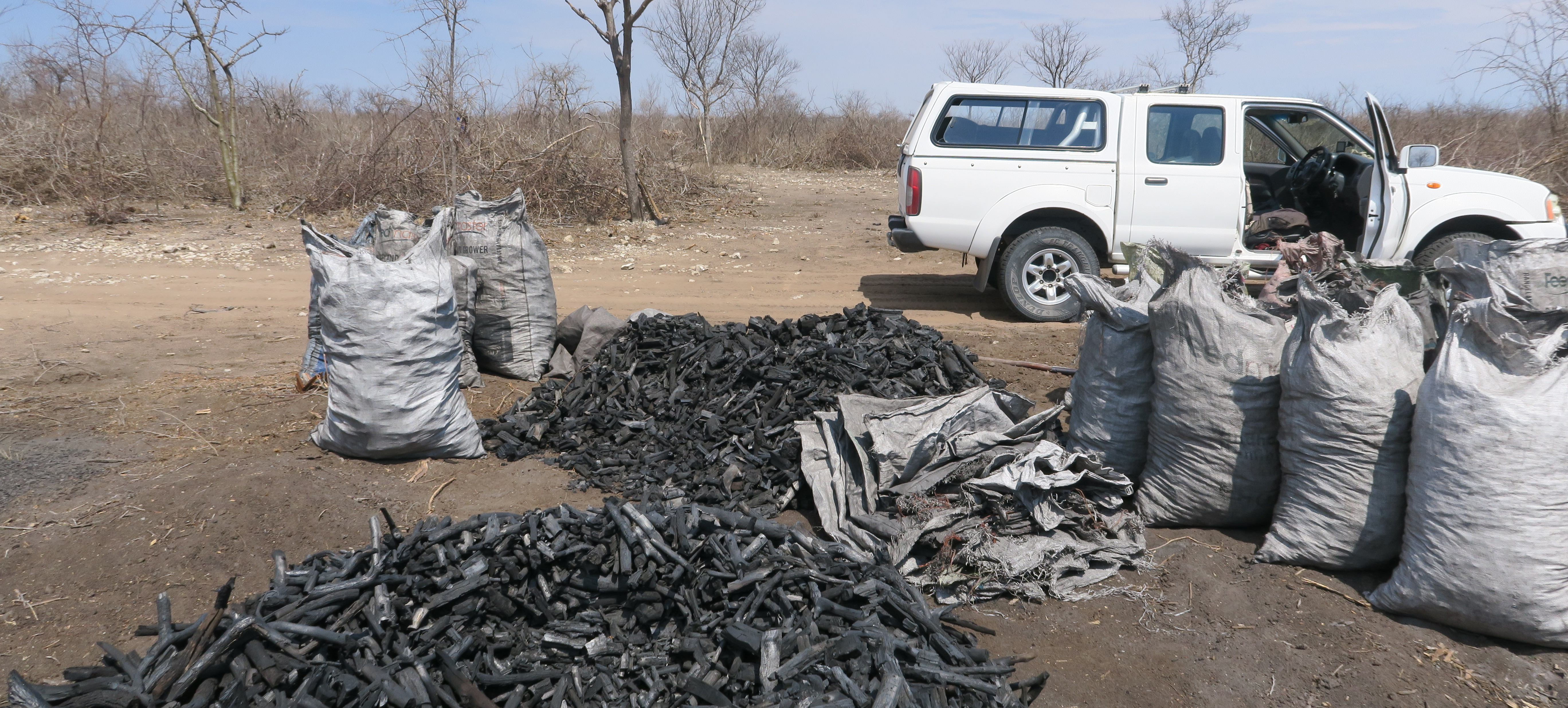 piles of raw charcoal on farm in Namibia 