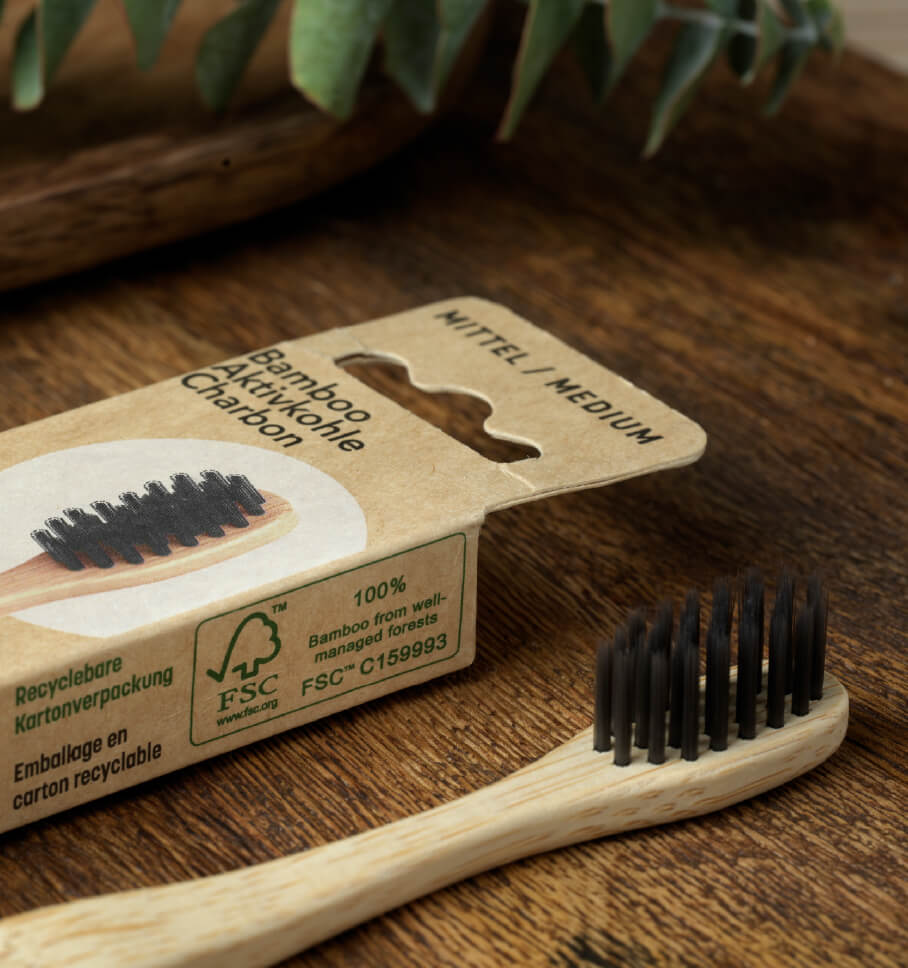 Photo of an FSC-certified bamboo toothbrush and its certified packaging.