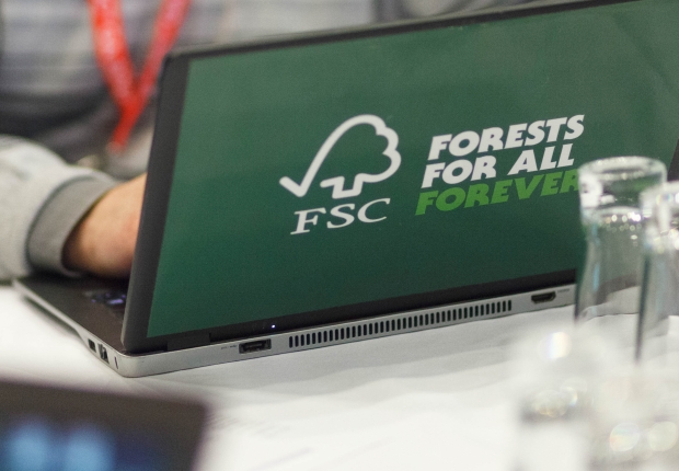 Person working on a laptop with a FSC sticker