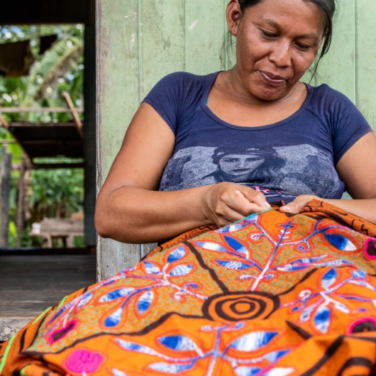 Woman sewing and handmade multicolored textile