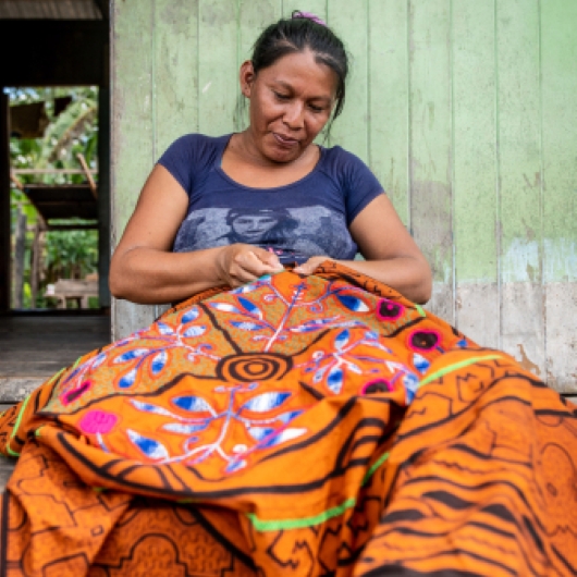 Woman holding a multicolored textile