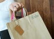 close up of a hand holding a paper shopping bag with FSC MIX Label