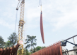 A crane lifts a piece of wood into place during construction of the French embassy in gabon