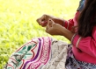 close up of Peruvian woman embroidering 
