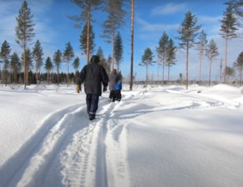 Three people walking through the snow