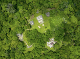 overhead drone view of Mayan ruins in forest fo Mayan Biosphere Reserve